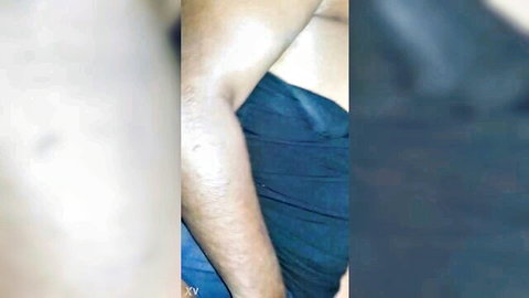 Ebony man's hairy muscular arm reaching out in blue shirt closeup