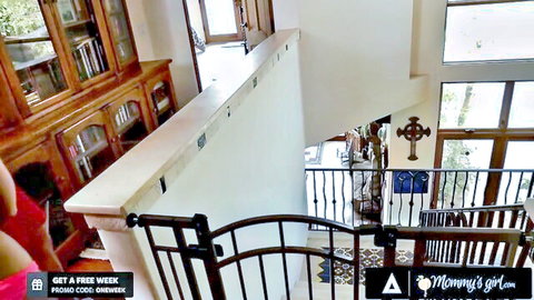 Busty Kendra Lust in pink dress with Sara Luvv on stairs in lesbian scene