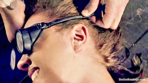 Bound brunette in goggles begs master for mercy in rough BDSM torment