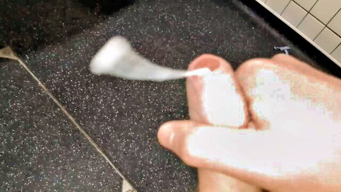 Amateur solo male cumshot close-up: hand holding thick semen strand