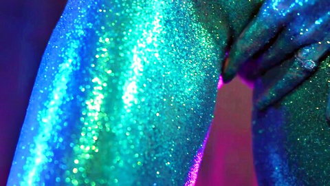 Glittery green body paint on model's arm after photoshoot tease