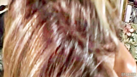 Blonde MILF with long wavy hair in intimate bedroom scene