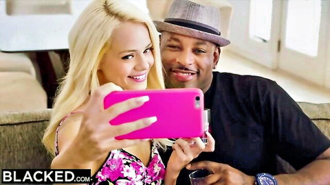 Elsa Jean blonde bombshell selfie with BBC stud in floral dress