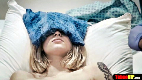 Blonde patient blindfolded during medical sponge bath and probe