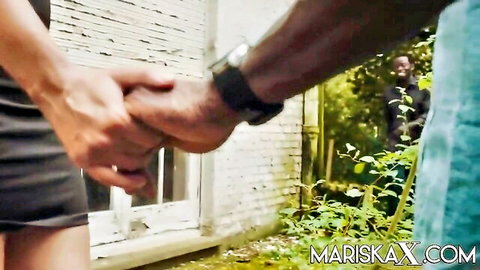 Interracial couple in short dress holding hands with voyeur peeking