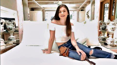 Smiling brunette bimbo in off-shoulder top and ripped jeans on bed