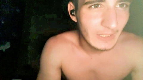 Omnitheone shirtless slim man smiling close-up in dim light