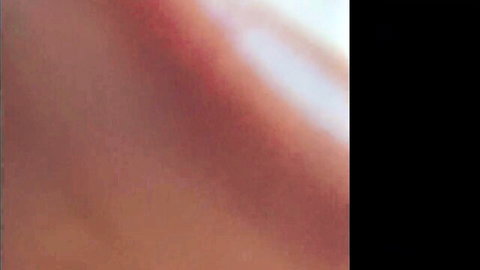 Blurry close-up of reddish pink skin tones in abstract erotic scene