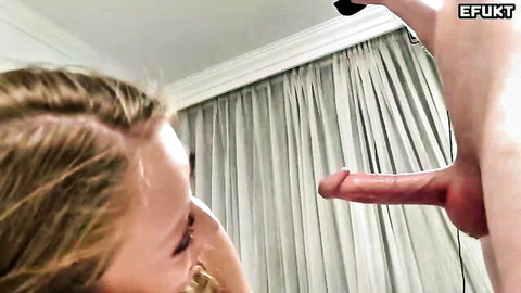 Blonde woman gazes at massive erect cock in close-up view