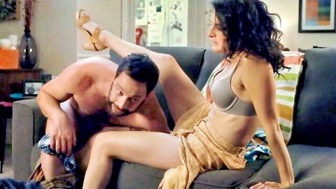 Jenny Slate in intimate couch foreplay with nude partner, leg up