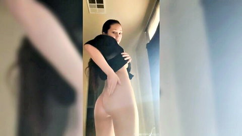 Asian babe with long hair lifting black top to flash bare nude ass cheeks from behind