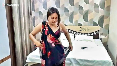Sexy Indian babe in black floral saree teasing deep cleavage in bedroom