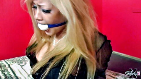 Blonde Asian babe ball gagged and bound in sheer black lingerie with big tits visible