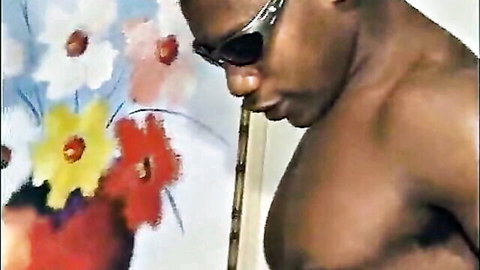 Muscular ebony hunk with sunglasses flexing ripped abs and chest