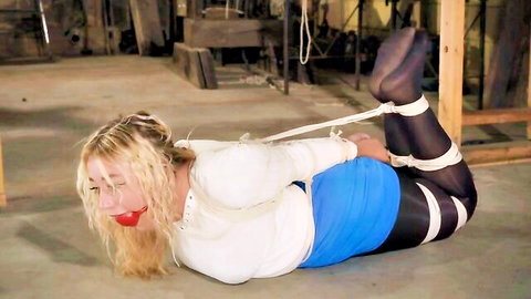 Blonde Zoey ziptied and hogtied in skirt and stockings, bondage scene