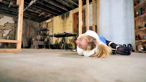 Blonde Zoey bound with zipties, struggling on floor in tight white top and pants