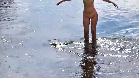 Nude woman bathing in Derzha River, outdoor rear view nudity