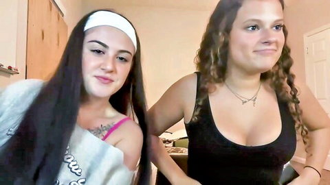 Two sexy teen girls with big tits and cleavage posing together in tank tops on webcam
