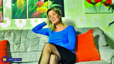 Blonde MILF Diana V in blue top, black skirt and stockings, solo tease