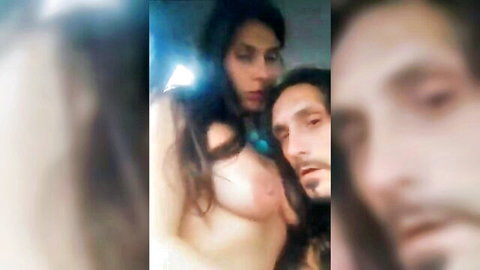 Brunette topless woman nuzzling bearded Jesus-lookalike man in intimate closeup