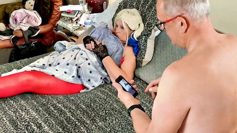 Granny Harley Quinn cosplay mature woman in red leggings with older man on bed