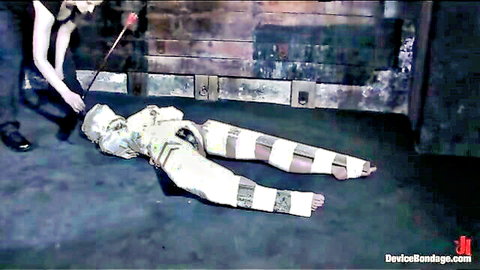 Bound slave struggles in custom white bondage gear on floor