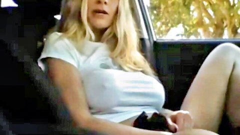 Blonde MILF in see-through white tee masturbates in car, webcam solo
