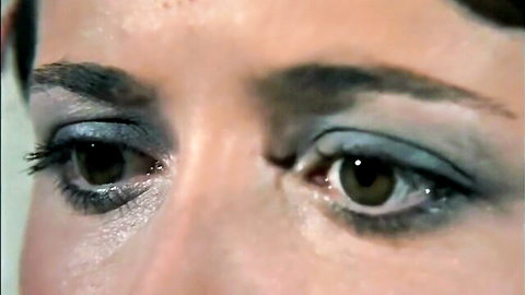 Seductive close-up of retro woman's smoky eyes in classic porn film