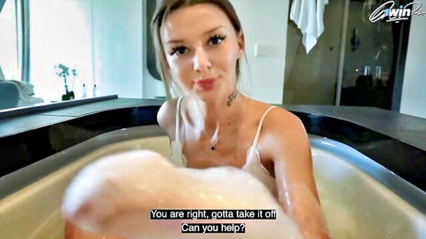 Leggy blonde beauty teasing strip in foamy bath