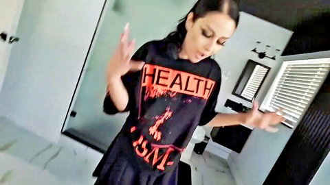 Latina babe dancing in tight black Health ISM shirt and mini skirt in modern bathroom