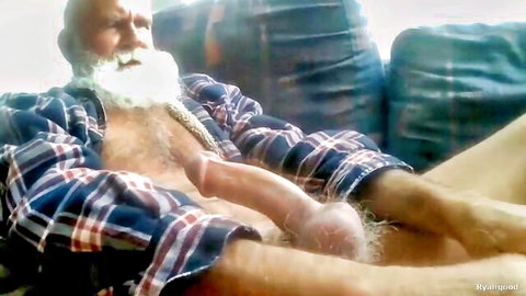 Bald bearded DILF exposes massive erect BWC and hairy balls in open plaid shirt on couch