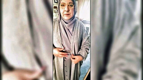 Mature Muslim woman in hijab trying on modest outfits