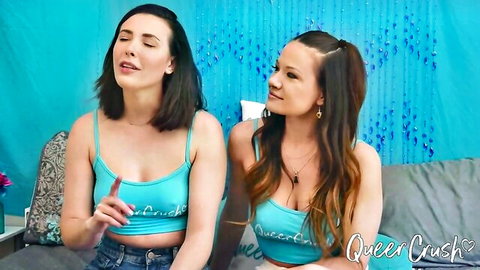 Two women in QueerCrush crop tops, smiling on couch, lesbian vibe