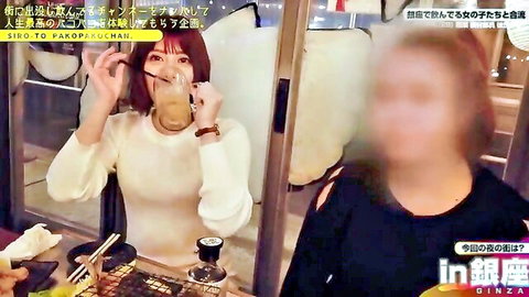 Red-haired Japanese woman in white sweater sipping drink, smiling in casual setting