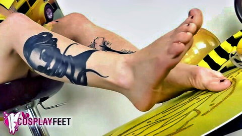 Hot cosplayer in bee costume shows bare feet and tattooed legs