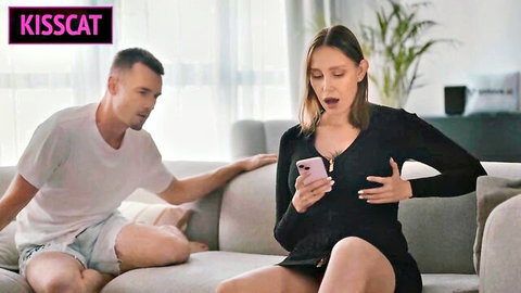 Step mom in black dress surprised by step son touching her on couch