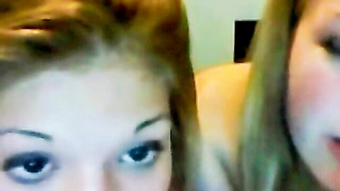 Two pretty light-haired lesbian webcam girls posing intimately close-up