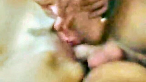 Tanned mature MILF eagerly sucking thick cock in intense closeup