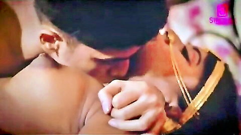 Passionate Desi bride and groom kissing on suhagraat wedding night