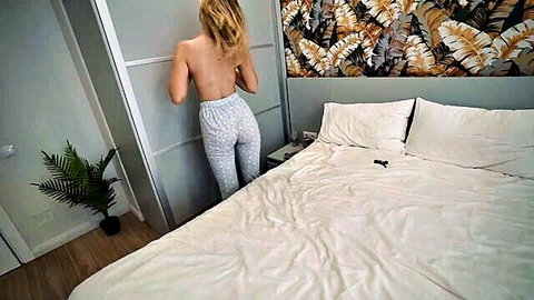 Blonde stepsister topless in pajama bottoms by hotel bed
