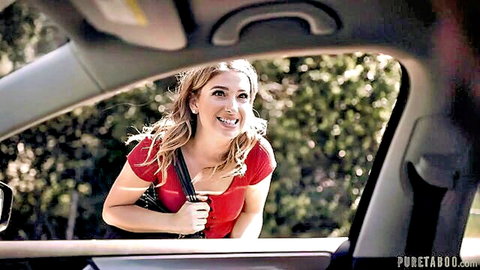 Blonde hitchhiker Kristen Scott smiling and leaning into car window in red top