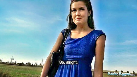 Brunette teen in tight blue dress stands outdoors for public agent casting