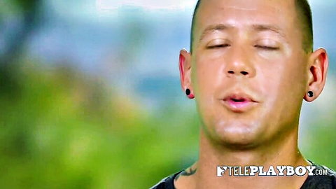 Closeup of bald man with earrings closing eyes mouth open in ecstasy