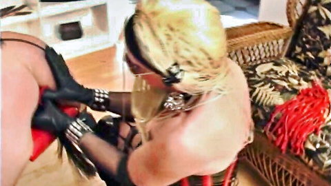 Blonde granny in red corset and gloves dominates step-daughter in femdom scene