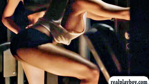 Tanned fit brunette babe with big tits pulls down shorts exposing ass and pussy bending over in gym
