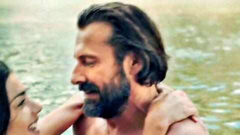 Bearded man and woman passionately embracing in pool water close-up