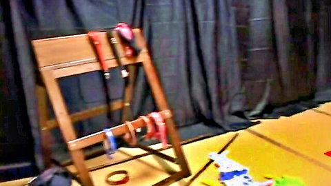 Bondage frame with red cuffs and straps for Japanese BDSM scene