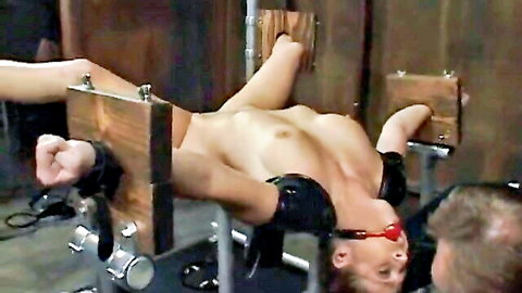 Redhead woman painfully tortured in tight bondage stocks, exposed and restrained