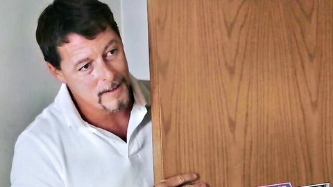 Curious man peeking from behind door during movie, teasing hidden blowjob action