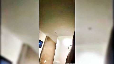 Blurry POV shot of indoor bathroom scene with beige walls